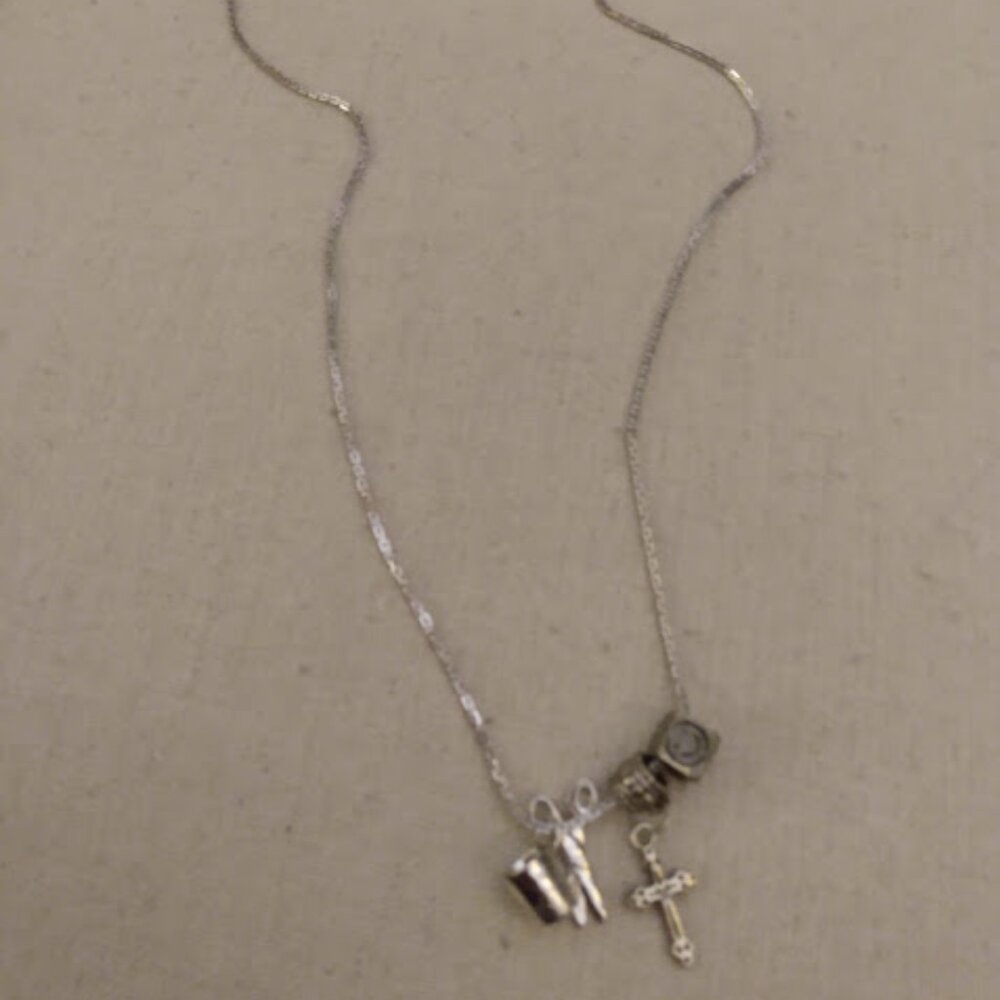 Silver tone charm necklace, Smiley face, Thimble, Cross, Scissors.